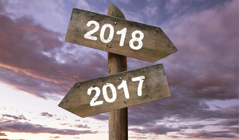 two signposts with 2018 pointing right and 2017 pointing left