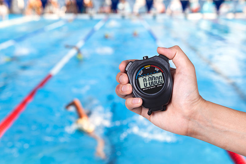 swimming pool with someone holding a stopwatch