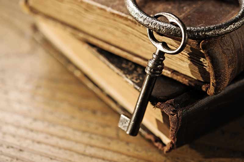 a key resting against some old books